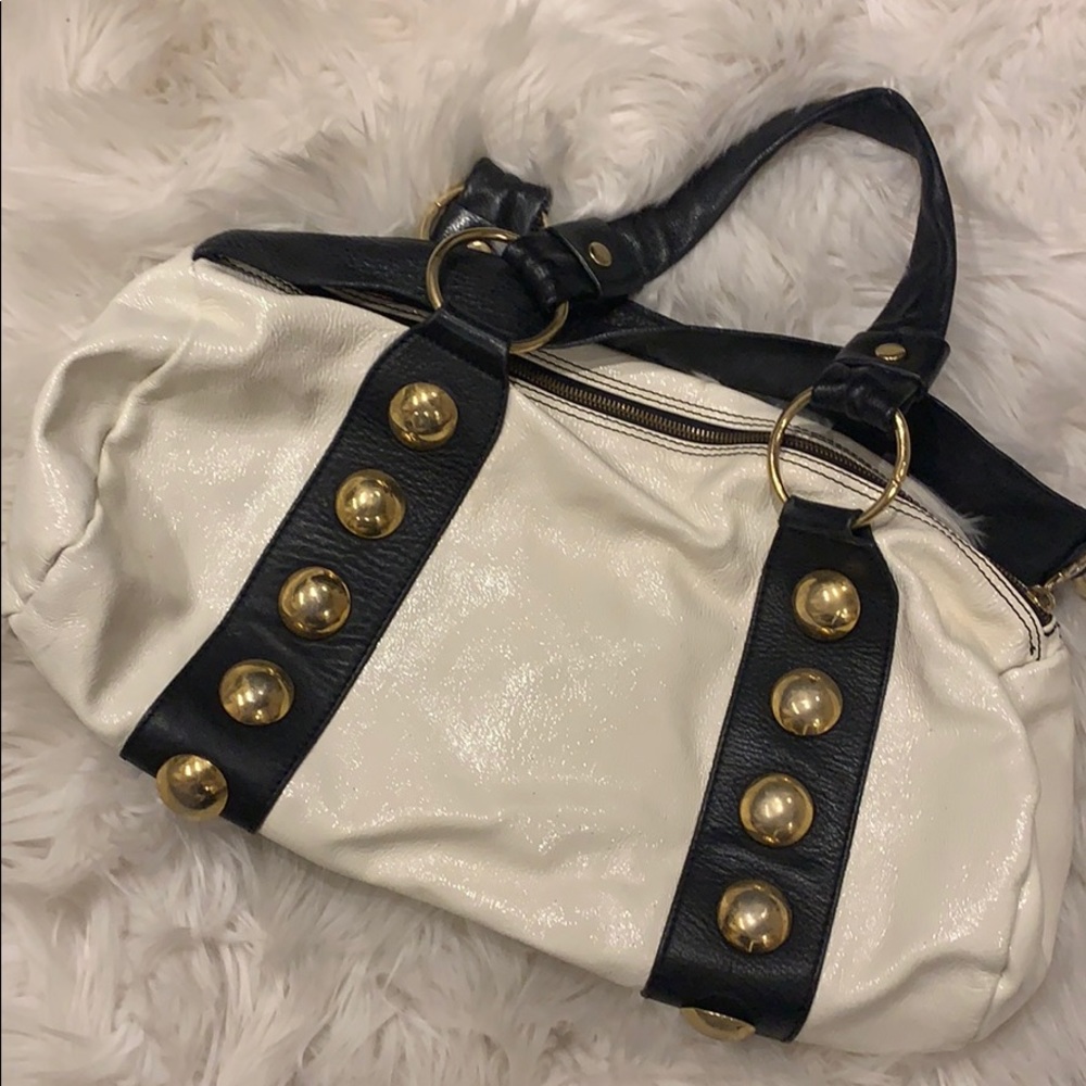 Black and white leather handbag with gold accents
